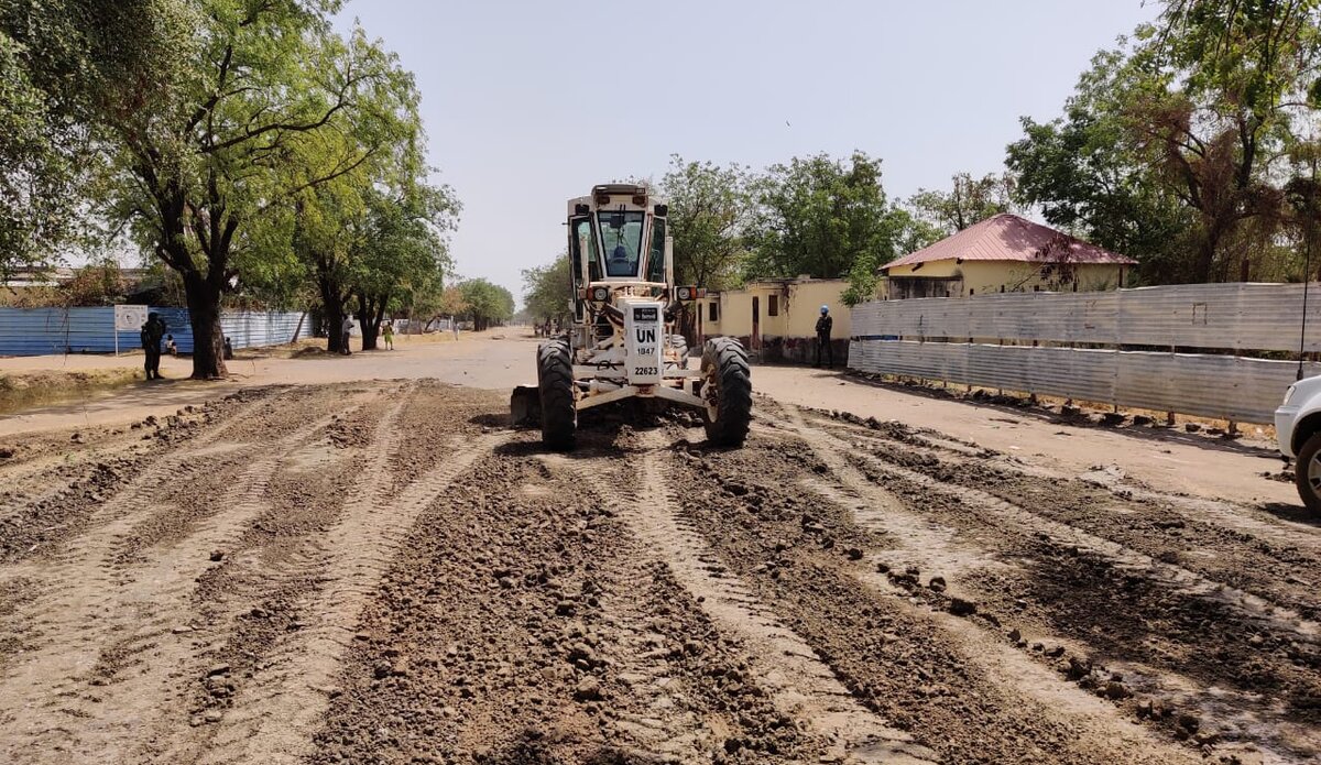 A construction machine lays the foundation for a smoother, safer journey, symbolizing progress in Bor's development.